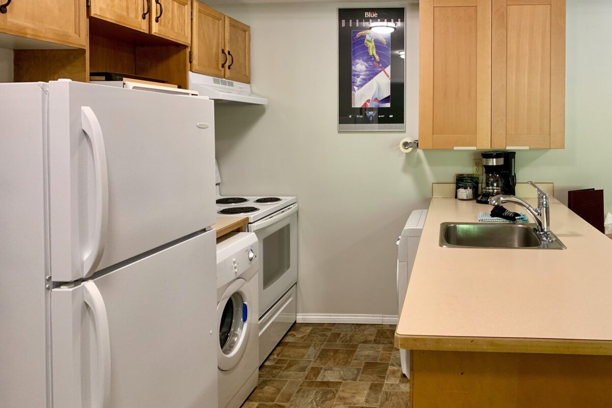 Small kitchen with fridge, appliances, and counterspace.