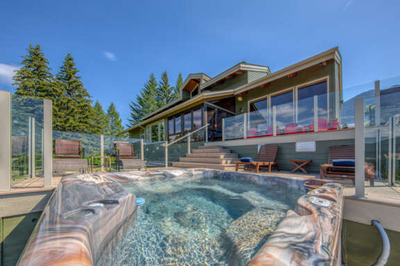 Hot tub with clear water on deck with 2 sun loungers