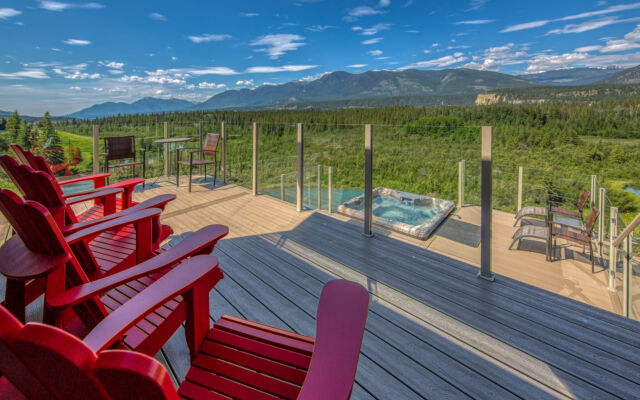 Hot tub with clear water on deck with 2 sun loungers
