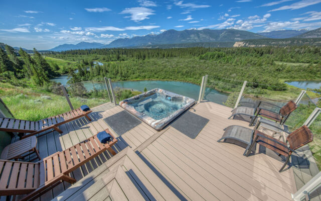 Hot tub with clear water on deck with 2 sun loungers