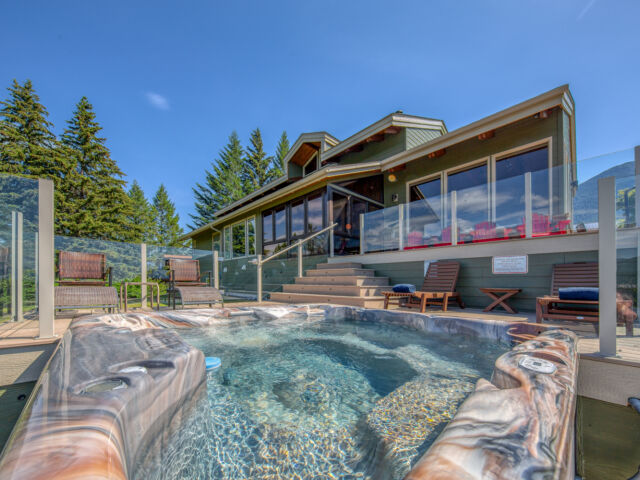 Hot tub with clear water on deck with 2 sun loungers