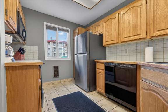 Kitchen with fridge, dishwasher and counter space at Tee House 3BR-13 in Mountain View Villas