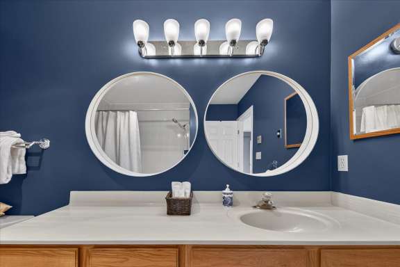 Ensuite bathroom with single vanity and mirror at Tee House 3BR-13 in Mountain View Villas