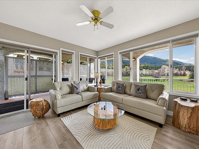 Living room with electric fireplace, Smart TV, golf course and mountain views at Tee House 3BR-13 in Mountain View Villas.