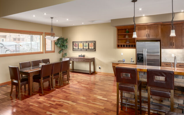 Living space with couches, television, and window to the left. Tall ceilings.