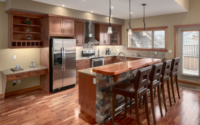 Living space with couches, television, and window to the left. Tall ceilings.
