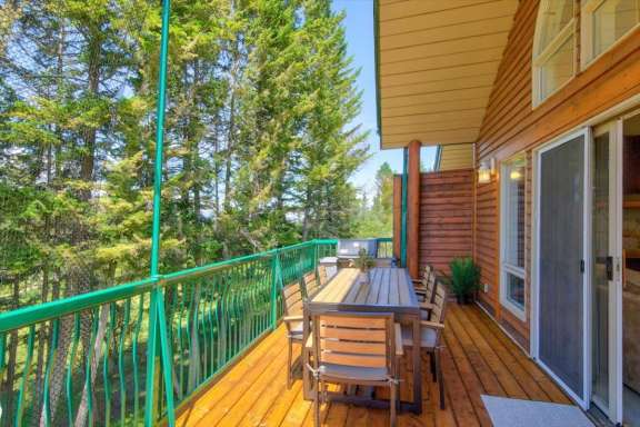 Large wrap-around upper deck with an outdoor dining table with seating for eight, gas BBQ and golf course views at Springs & Swings - Marble Canyon 504 - Phase 1.