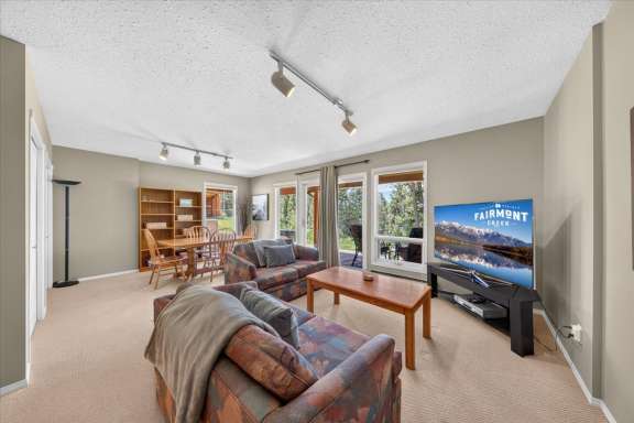 Lower-level family room with comfortable seating, Smart TV, books, games and a table for cards and board games at Springs & Swings - Marble Canyon 504 - Phase 1