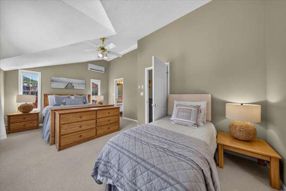 Spacious upper-level master bedroom with a queen bed, twin bed, air conditioning and private ensuite bathroom in Springs & Swings - Marble Canyon 504 - Phase 1.