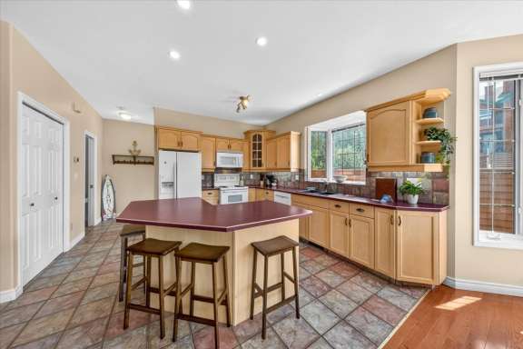 Fully equipped kitchen with large island, seating, and full-size appliances at Marble Canyon 704 Phase 2 in Fairmont Hot Springs.