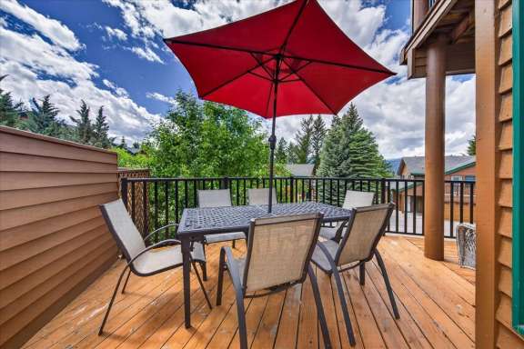 Large private deck with outdoor dining table, seating for six, mountain views and outdoor living space at Marble Canyon 704 Phase 2 in Fairmont Hot Springs.