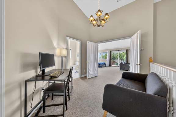 Dedicated workspace with desk, monitor and seating area on the upper-level landing at Marble Canyon 704 Phase 2 in Fairmont Hot Springs.