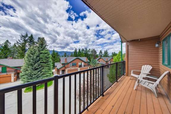 Private balcony off Bedroom 2 with outdoor seating and mountain views at Marble Canyon 704 Phase 2 in Fairmont Hot Springs.
