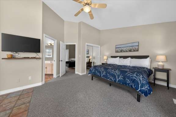 Master bedroom with king bed, Smart TV and access to the ensuite shower room and private balcony at Marble Canyon 704 Phase 2 in Fairmont Hot Springs.