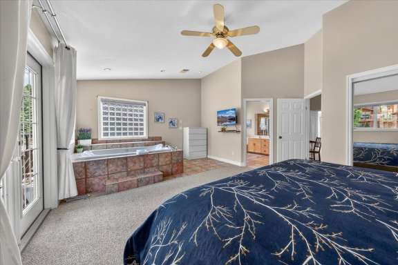 Master bedroom with king bed, in-room jacuzzi tub, Smart TV and access to the ensuite shower room at Marble Canyon 704 Phase 2 in Fairmont Hot Springs.