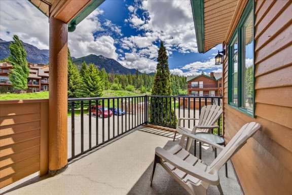 Private balcony off the master bedroom at Marble Canyon 704 Phase 2 featuring comfortable seating, mountain views and a peaceful outdoor retreat in Fairmont Hot Springs.