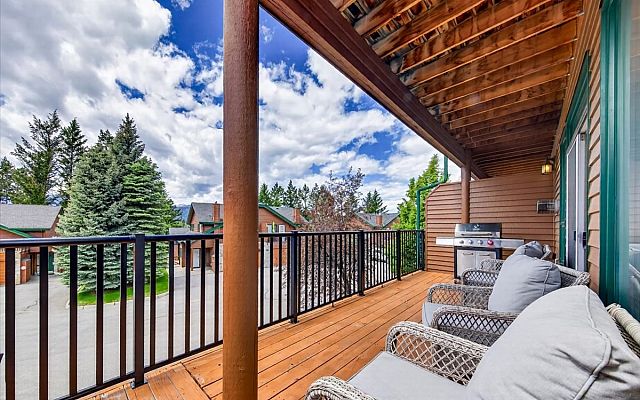 Exterior of Marble Canyon 704 Phase 2 showcasing the large deck, private balconies, and stunning mountain views in Fairmont Hot Springs.