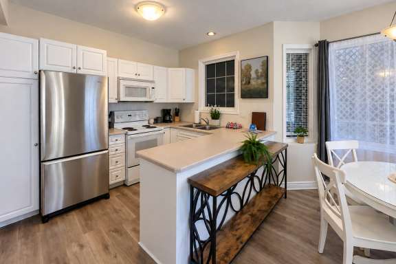 Bright kitchen at Little Falls Landing with full-size appliances, ample counter space and an open layout adjoining the dining area