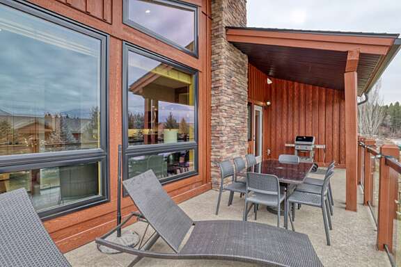 Partially covered deck with BBQ, dining area and sun loungers