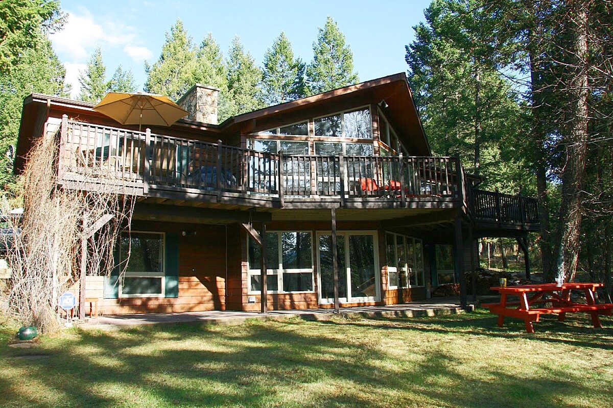 Large cabin with open concept. Surrounded by greenery and trees.