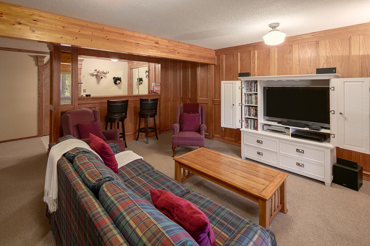 Living space and recreation area. Couch, television, and bar seating.