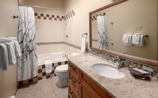 Large cabin with open concept. Surrounded by greenery and trees.