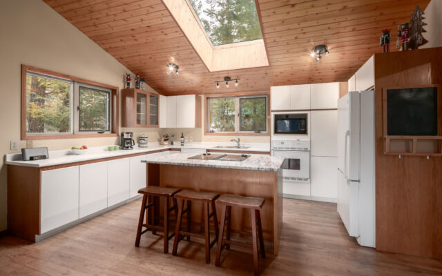 Large cabin with open concept. Surrounded by greenery and trees.