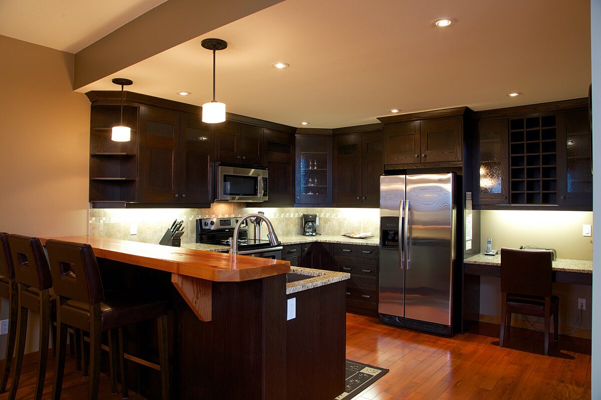 Spacious kitchen with black cabinets, stainless steel appliances, and counterspace.