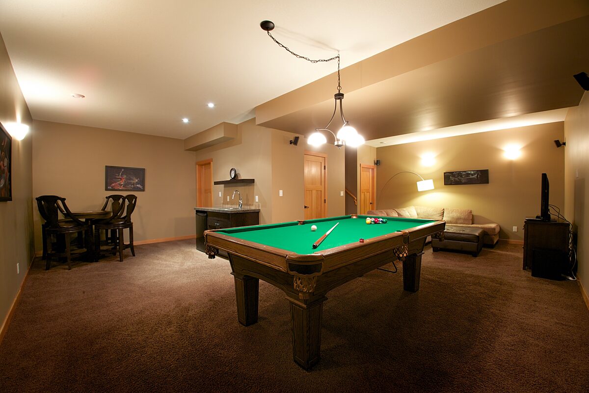 Living space with pool table, wet bar, and seating.