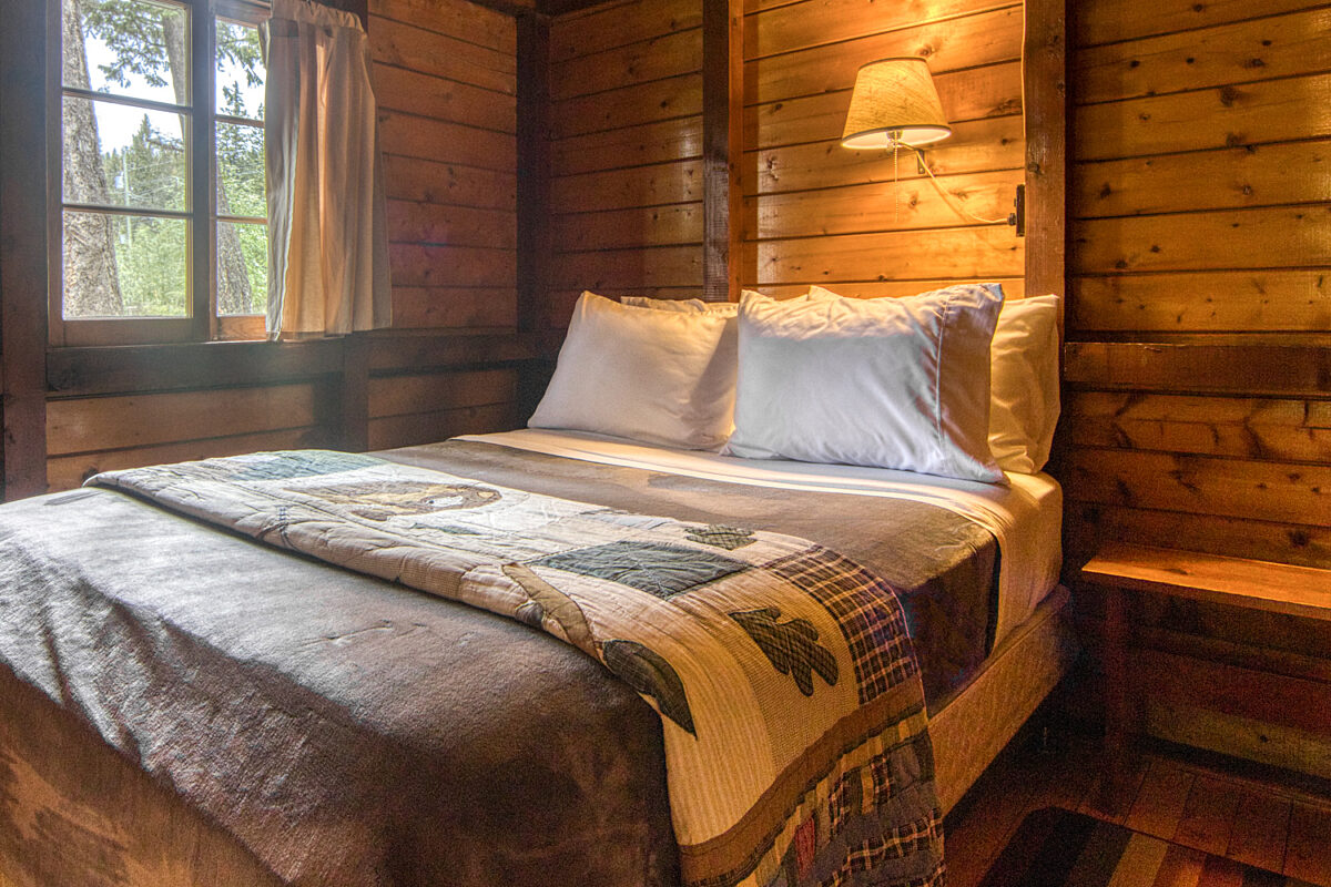 Double bedroom in wood panelled cabin