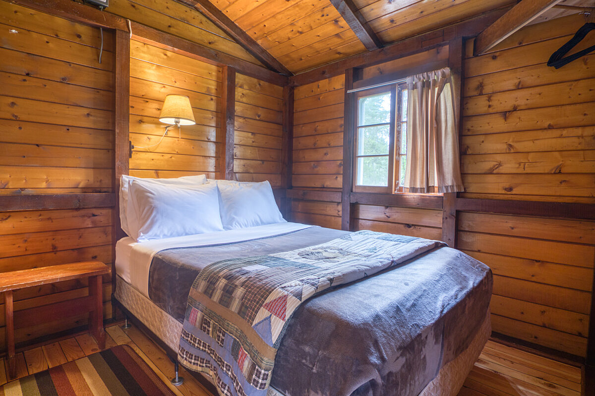 Double bedroom in wood panelled cabin
