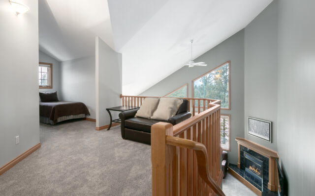Living room area with two red leather couch, chair, coffee table, and television