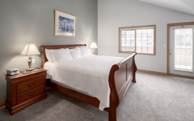 Living room area with two red leather couch, chair, coffee table, and television