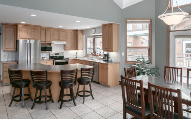 Living room area with two red leather couch, chair, coffee table, and television