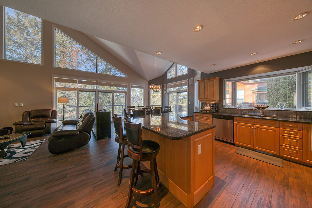 Kitchen area with modern appliances, cooking space, and windows.