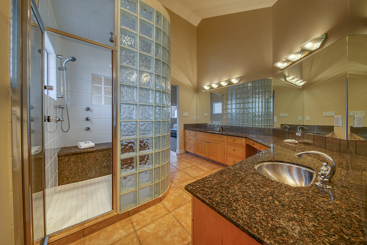Ensuite bathroom of the master bedroom with sink, shower, vanity.
