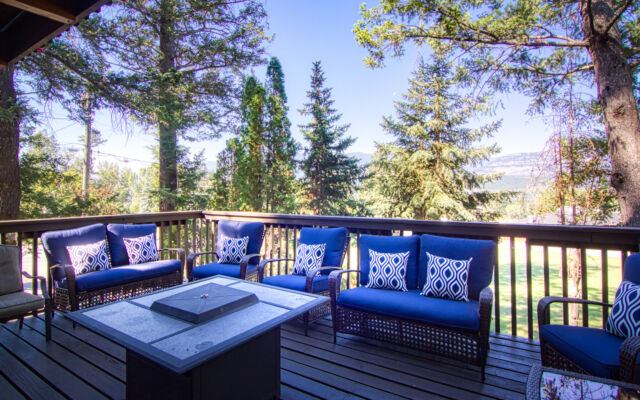Wood panelled cabin surrounded by trees.