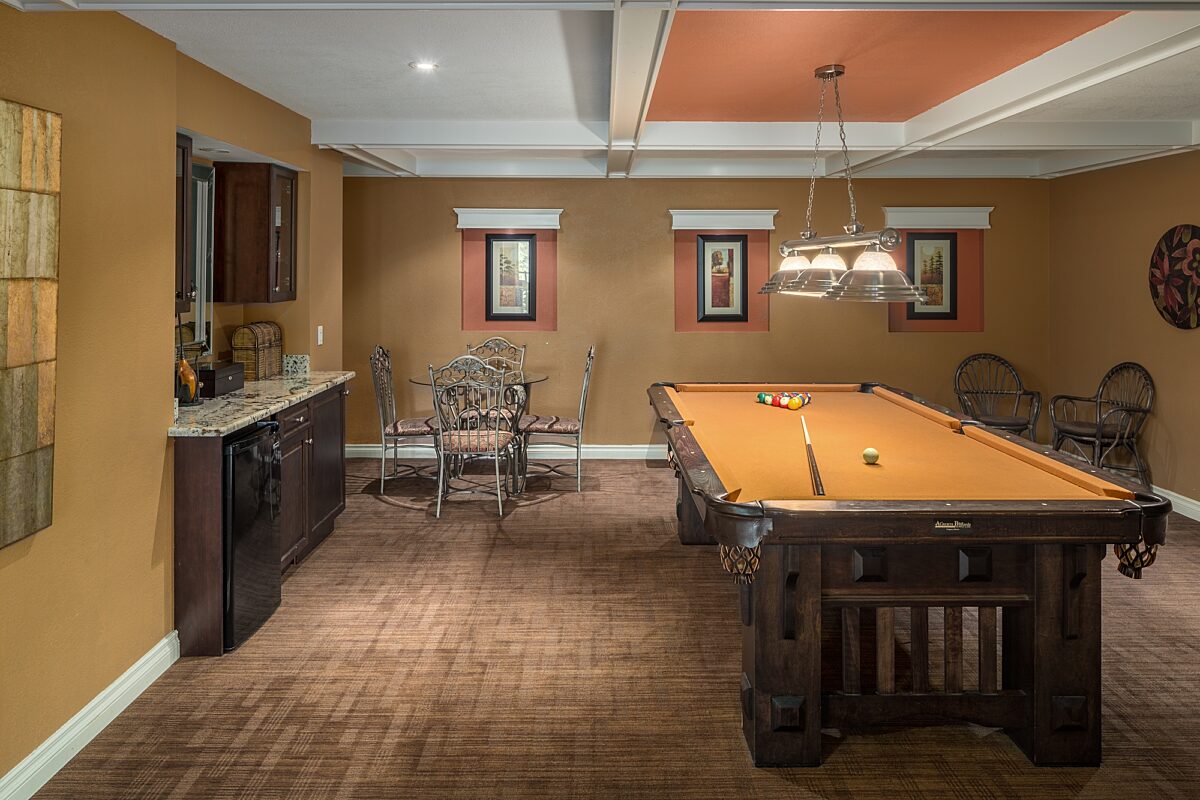 Recreation room with pool table, wet bar, and seating areas.