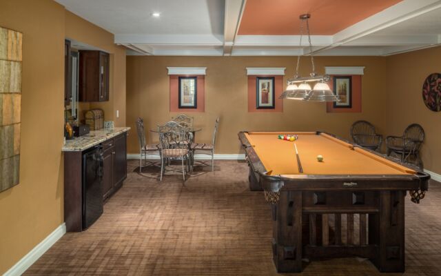 Spacious kitchen with island, barstools, appliances, and dining space to the rear.