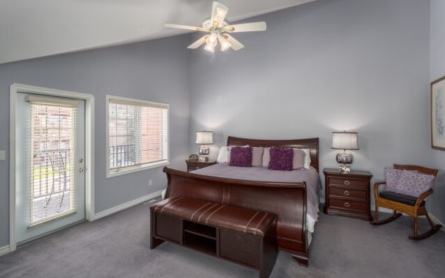 Spacious kitchen with island, barstools, appliances, and dining space to the rear.