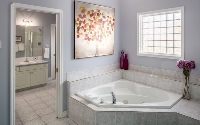 Spacious kitchen with island, barstools, appliances, and dining space to the rear.