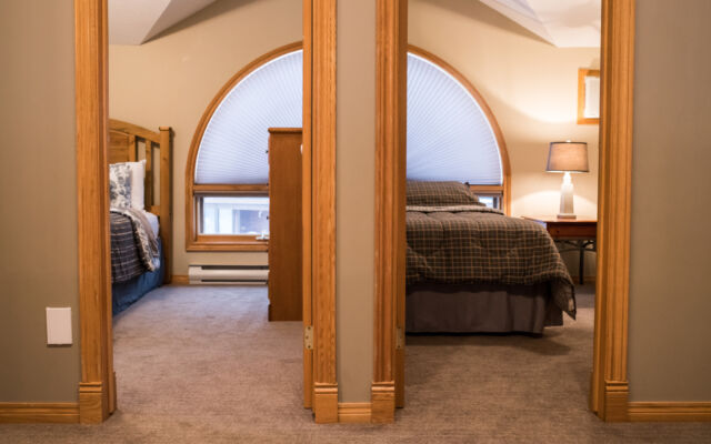 Living and dining areas as viewed from a loft above. Table and chairs, couch, and coffee table included.