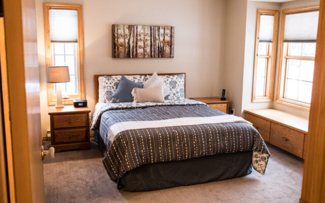 Living and dining areas as viewed from a loft above. Table and chairs, couch, and coffee table included.