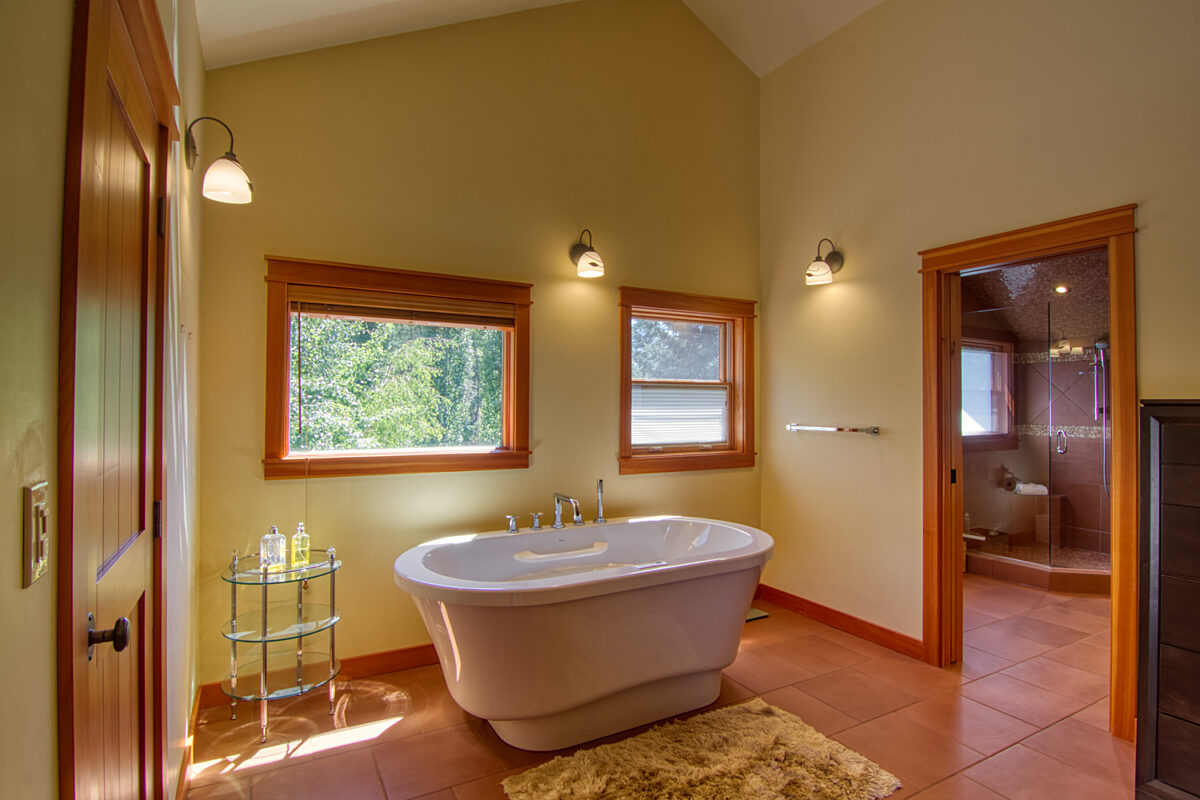 Bathroom with a standalone soaker tub, two windows ensuite to the master bedroom.