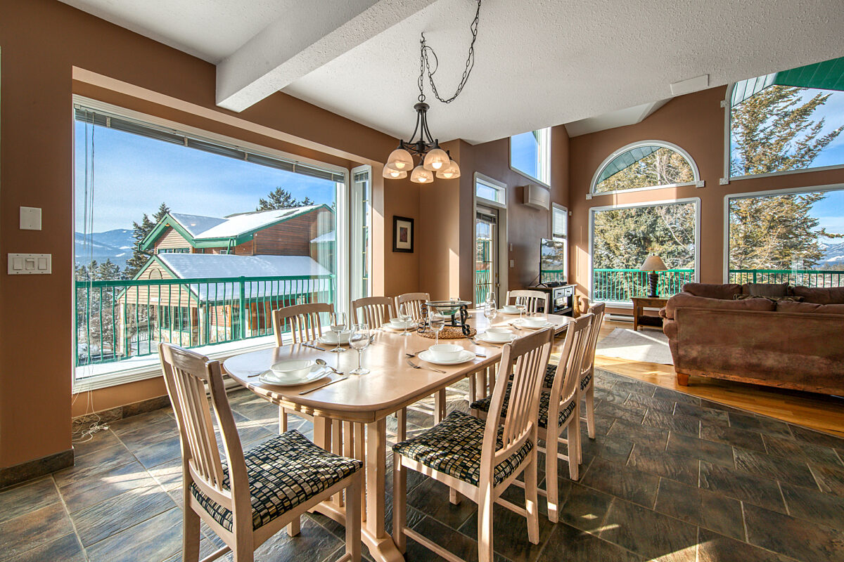 Dining area with large windows. Dining table and chairs.