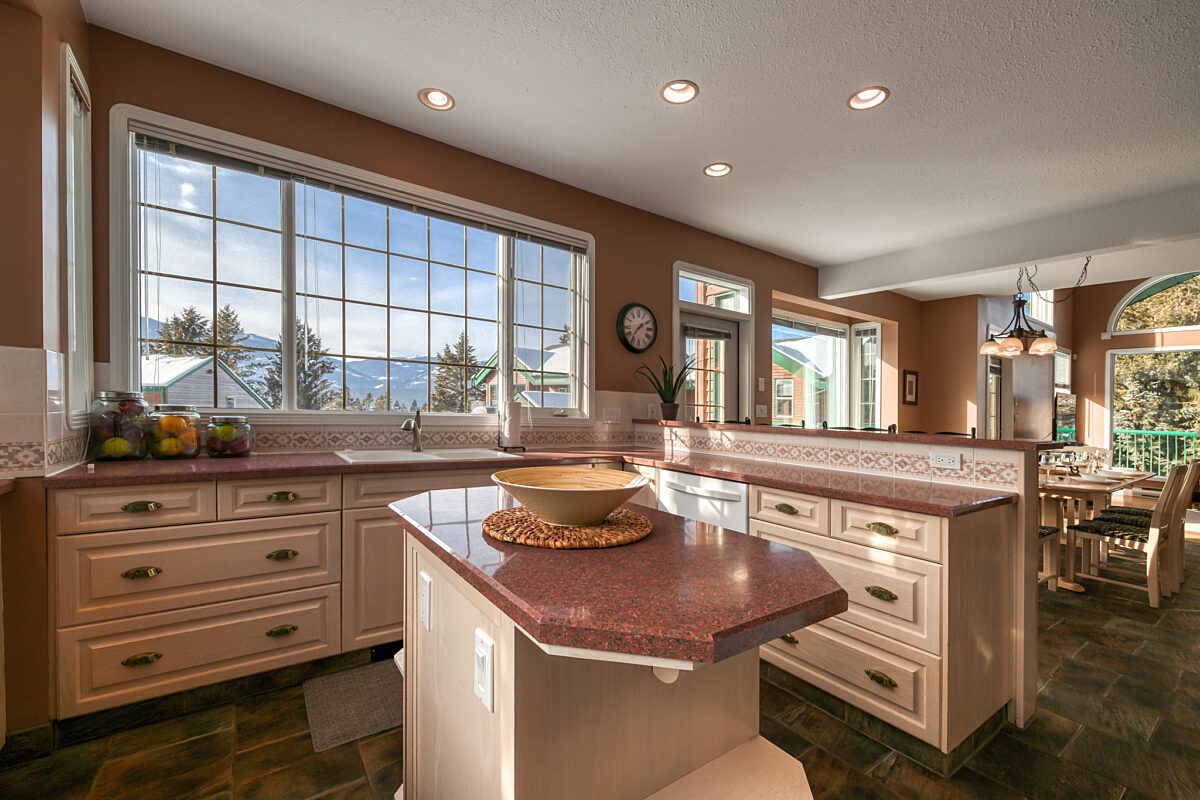 Kitchen with island, counterspace, appliances, and cabinets.