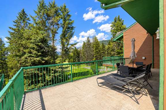 Wrap-around deck at Marble Canyon 102 - Phase 1 with outdoor dining, sun loungers, gas BBQ, and scenic valley and mountain views.