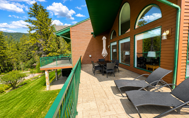 Dining area at Marble Canyon 102 - Phase 1 with seating for 8, floor-to-ceiling windows, open-concept living space and stunning golf course and mountain views.