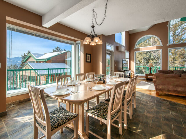 Dining area with large windows. Dining table and chairs.