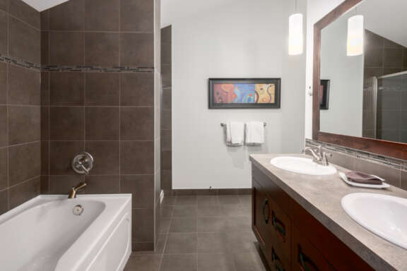 Bathroom with bathtub, shower, double sinks